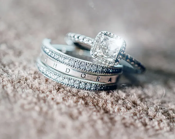 Wedding and engagement rings stacked together