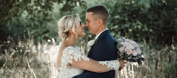 A couple close together in a garden