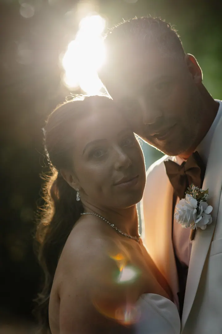 Hayley and Marco glowing in golden hour light in the woods at Fairlawns